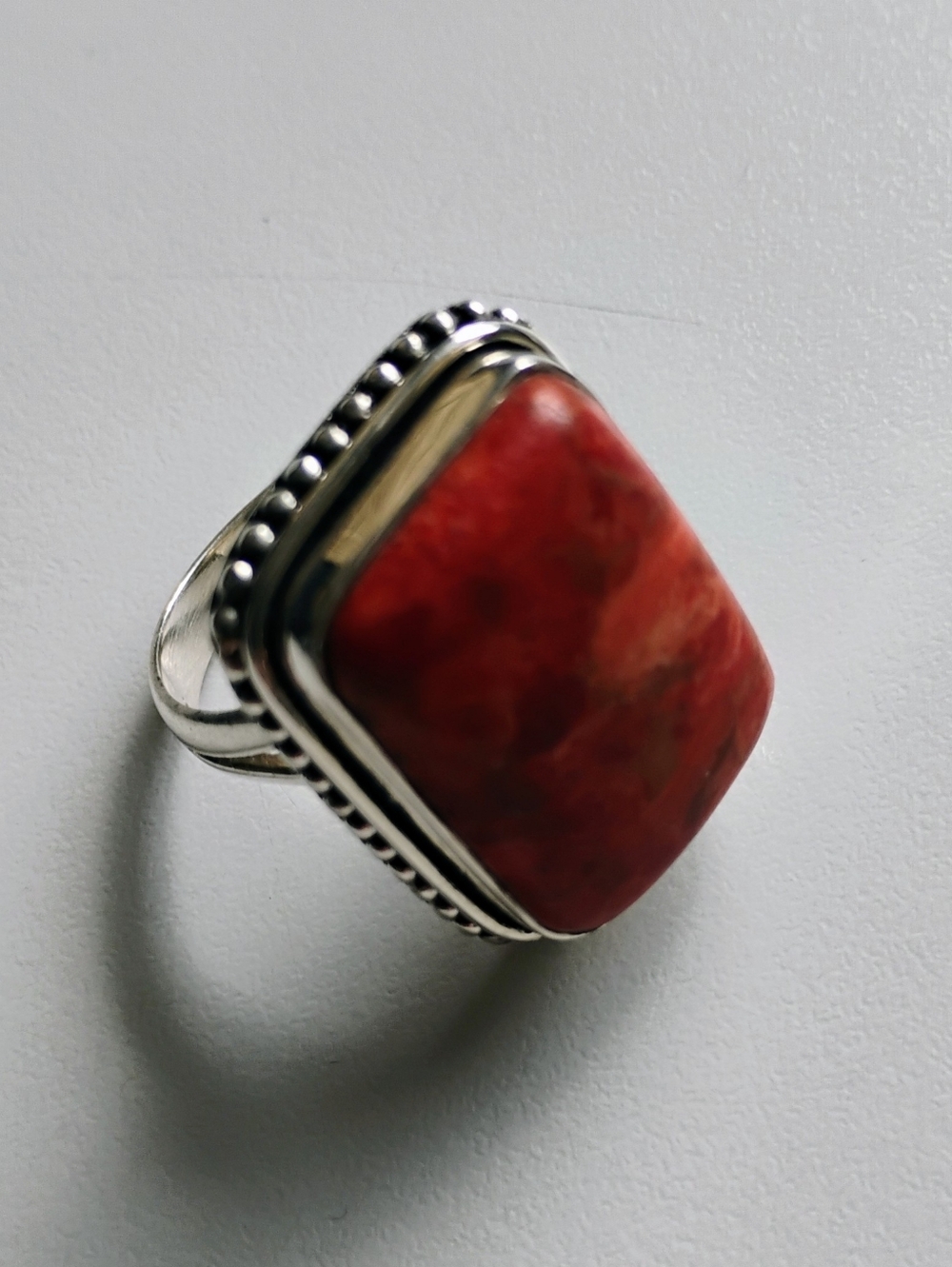 Rectangular ring with an orange (turquoise orange?) stone in sterling silver